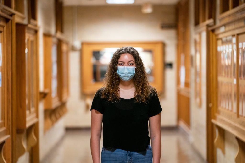 a young woman wearing a mask