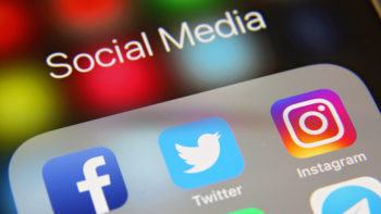faceboo, twitter and instagram icons on a phone screen