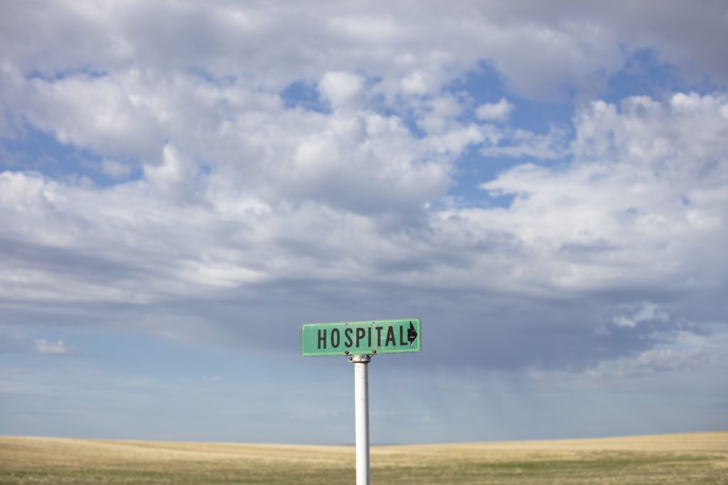 hospital sign with field in background