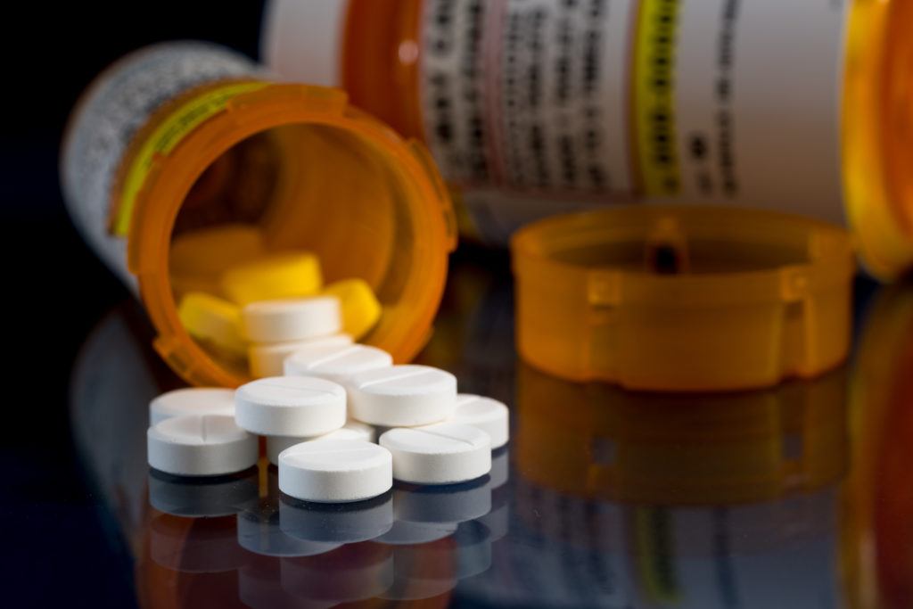 pill bottles and tablets on glass table