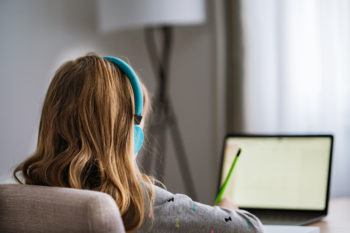 Rear view of girl with headphones using