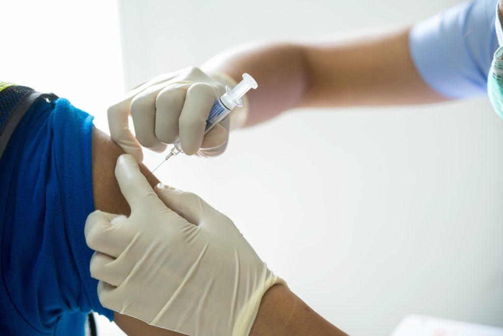 close up of doctor giving a flu shot