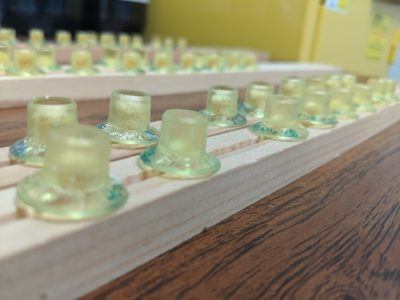 rows of small cups filled with mixes for bees to eat