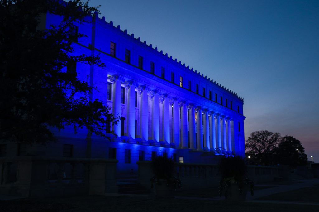 blue light shining on the administration building exterior