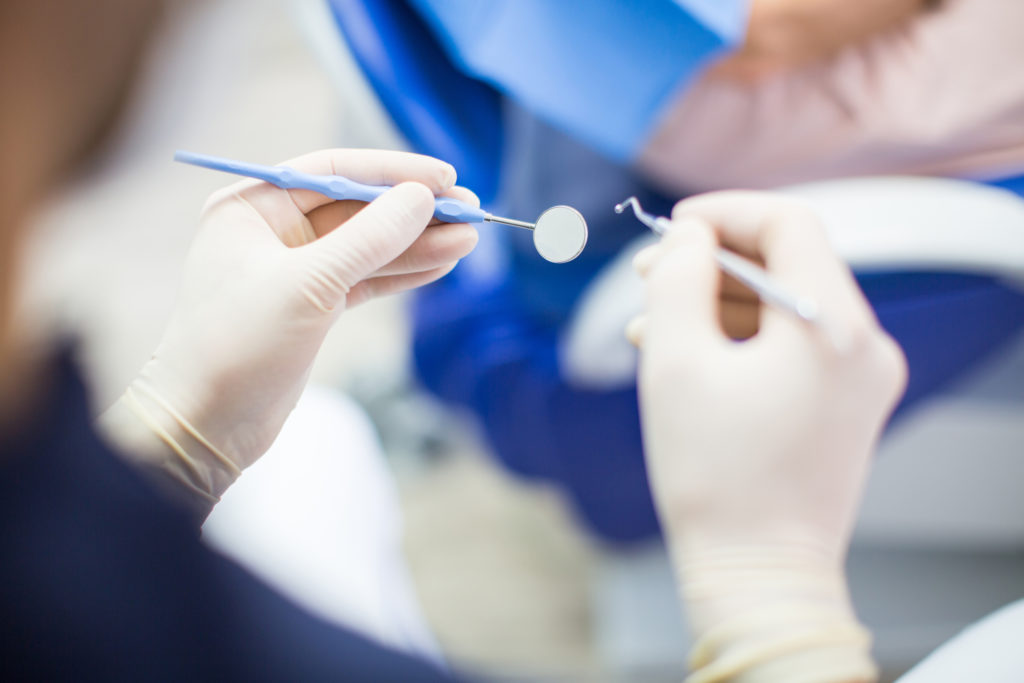 Dentist at work with tools