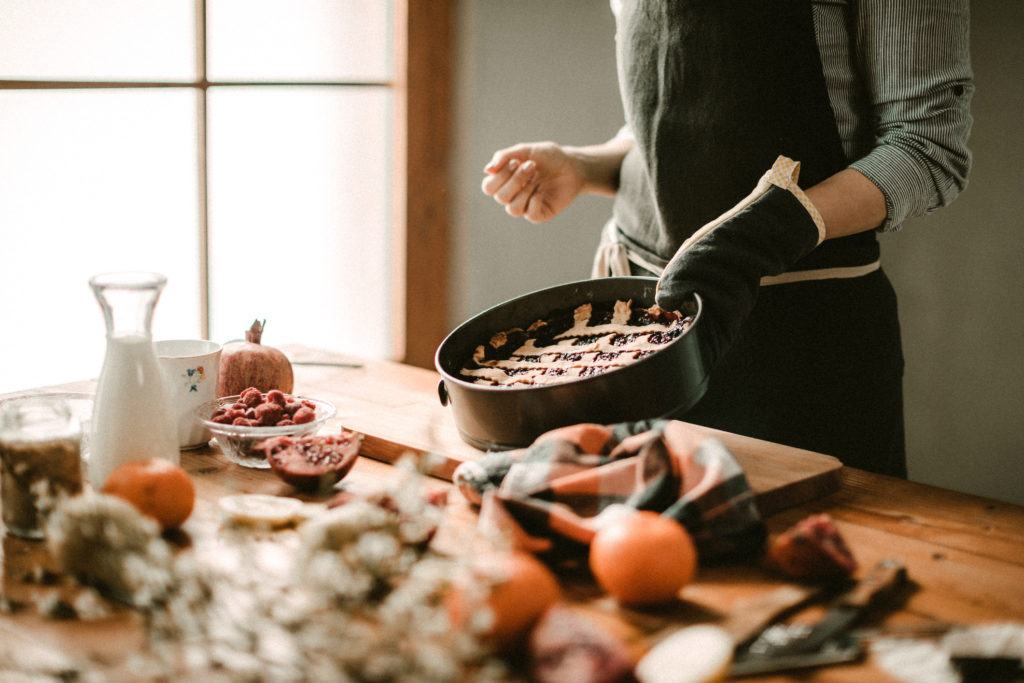image of woman preparing pie in kitchen