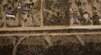 aerial view of rural community along the border