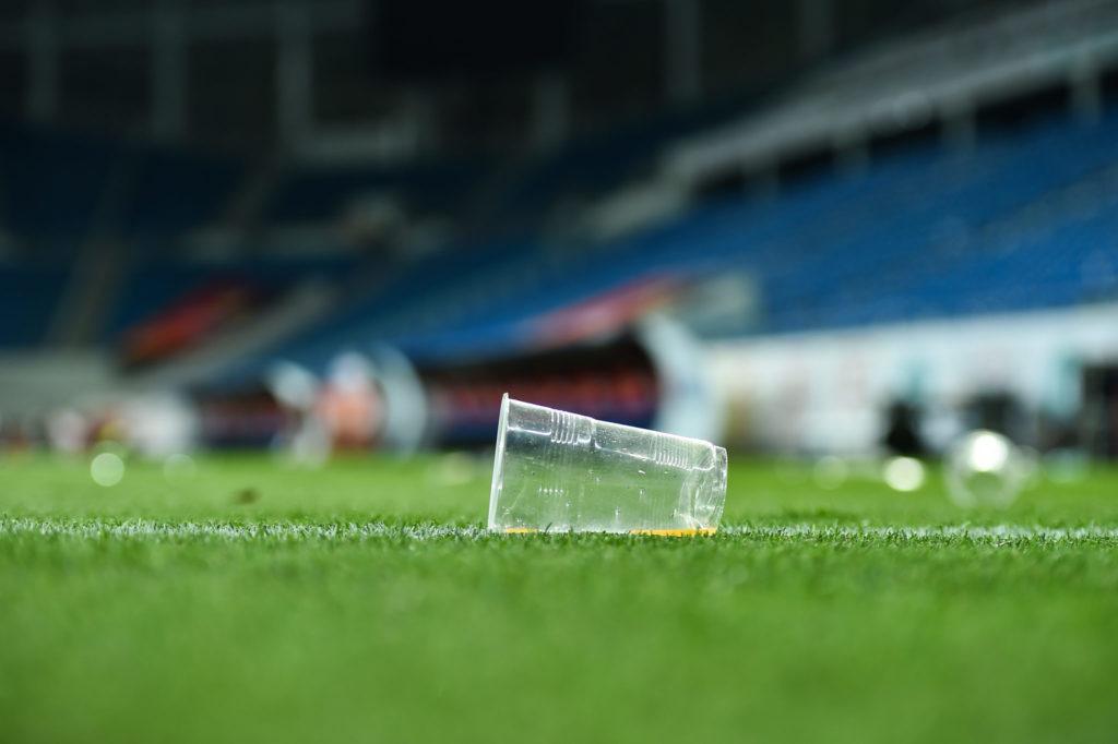 empty plastic cup on a soccer field