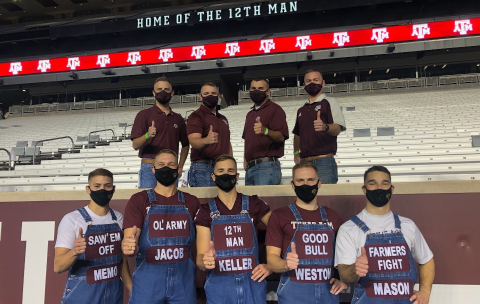 Texas A&M and Galveston Yell Leaders pose with thumbs up at Kyle Field after Midnight Yell on Oct. 30, 2020