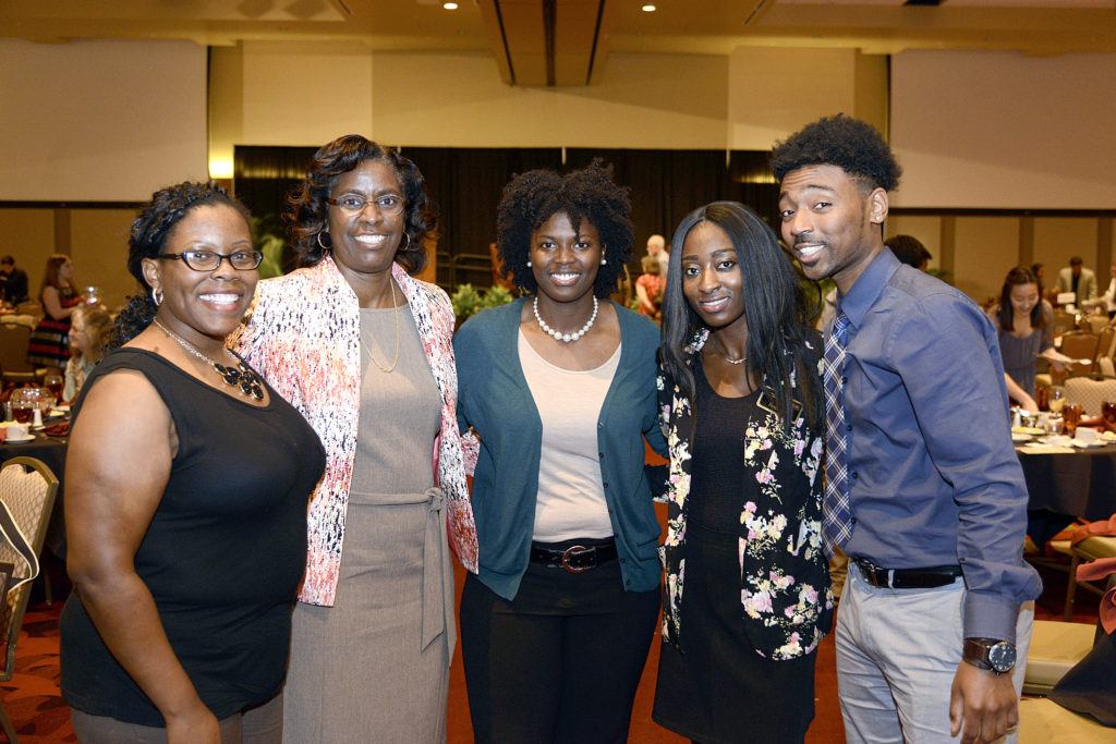 Butler-Purry poses with graduate students at a university event