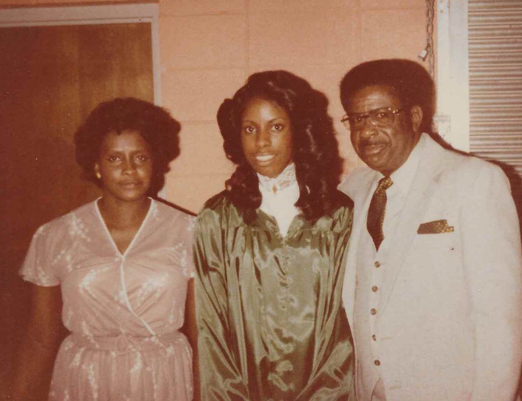 Karen Butler-Purry as a teen posing with her parents