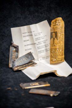 memorabilia including a newspaper clipping, name tags and program