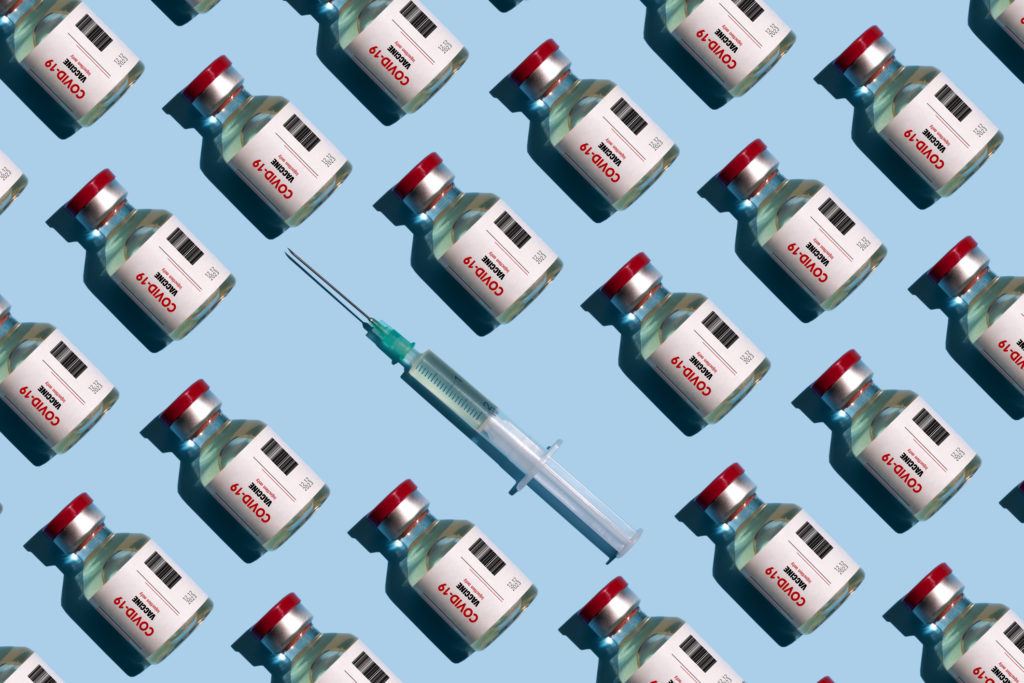 repeated vials and syringes against blue background