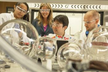 Karen Wooley in the lab with three students