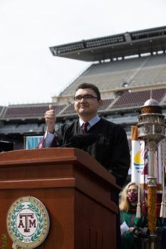 Mendoza giving the Gig 'em thumb at graduation March 13 at Kyle Field