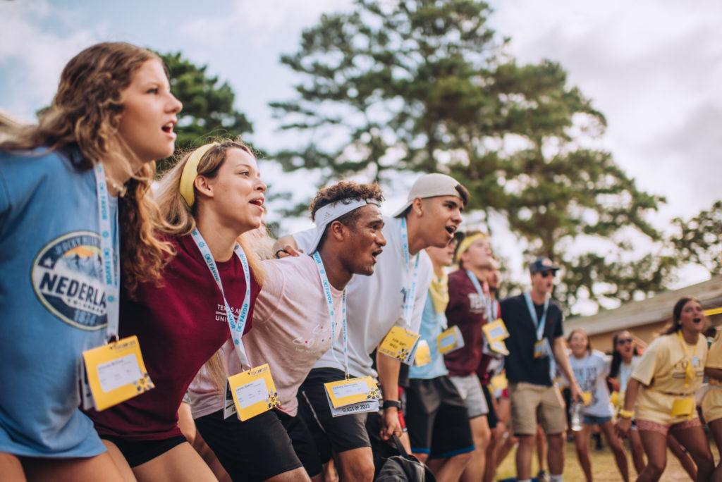 Students singing aggie war hymn at fish camp
