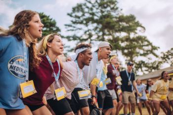 Students singing aggie war hymn at fish camp