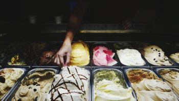 Cropped Hands With Various Ice Cream In Containers