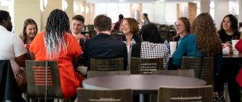 m. katherine banks seated with students in foreground