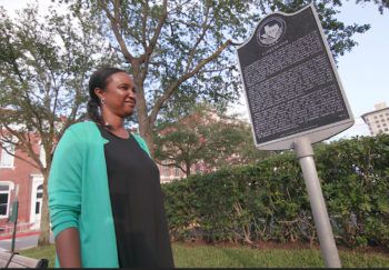 carol bunch looking at historical marker