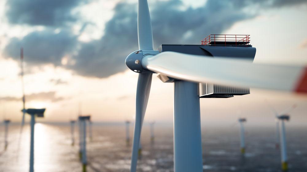 photo of several wind turbines standing in the ocean