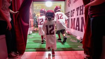 a photo of children in A&M jerseys running through a Texas A&M brand experience