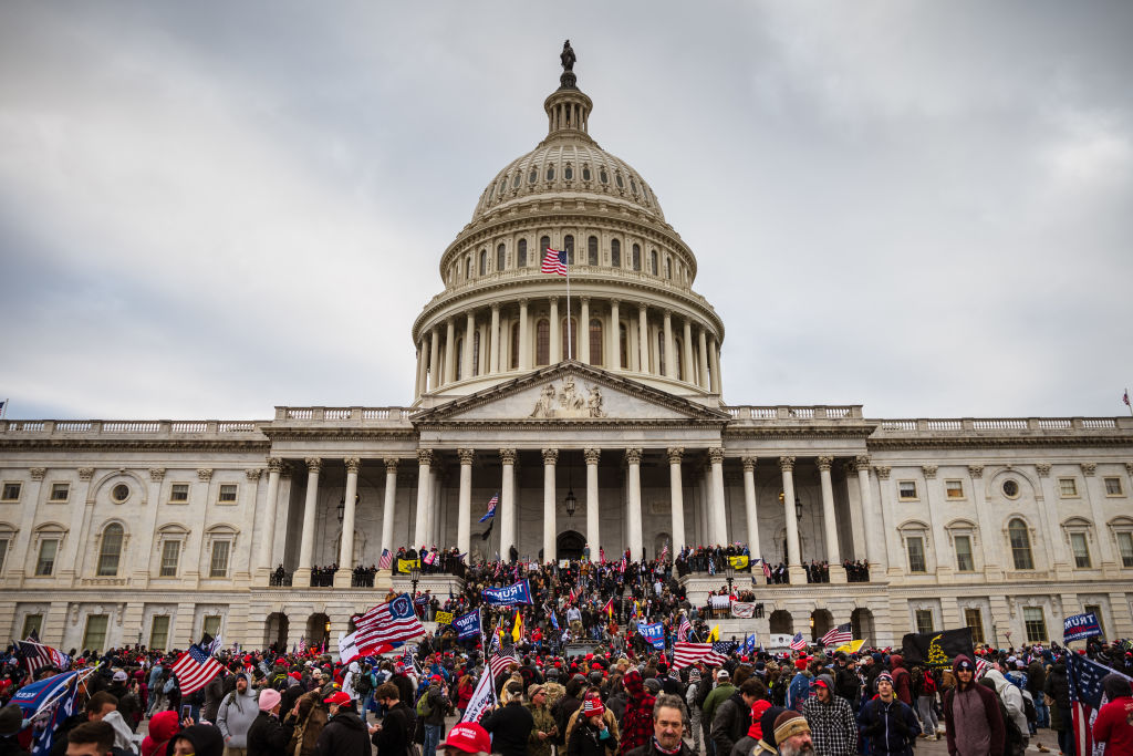 large group of trump supporters gathered on steps in front of u.s. capitol building