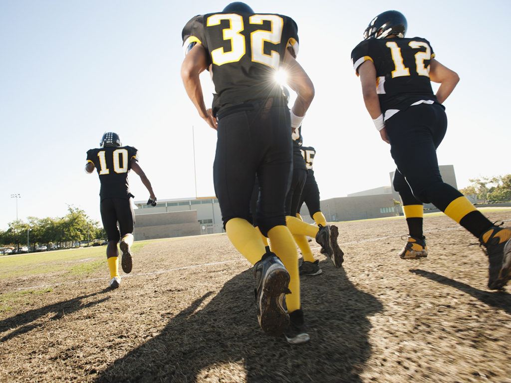 football players running on the field