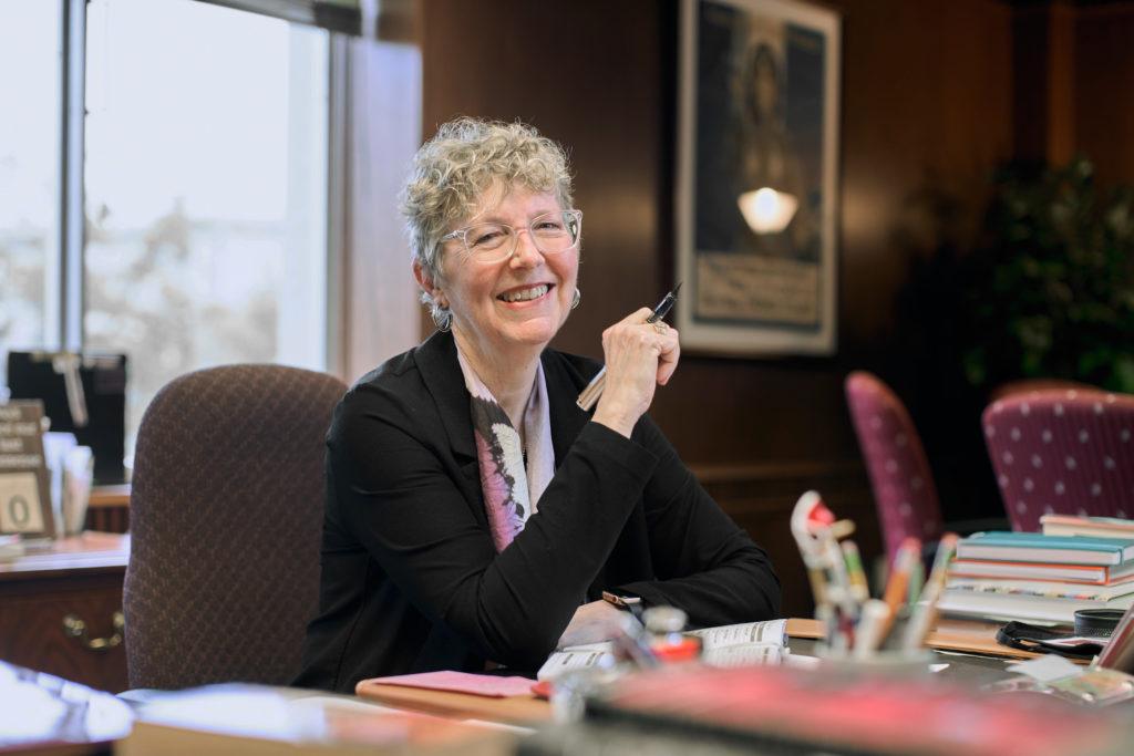 portrait of matthews sitting at her desk