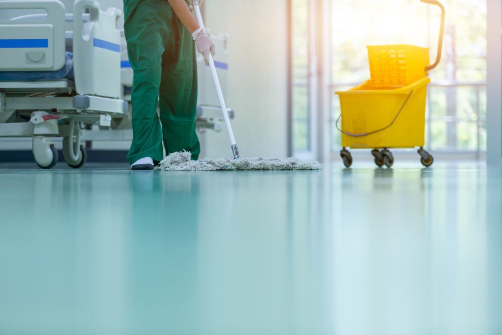 cropped image of person mopping floor in hospital