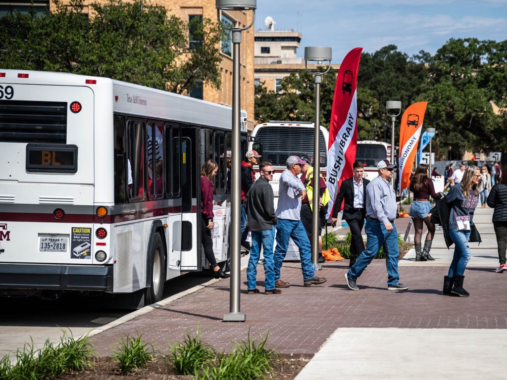 people step off buses on the texas a&m campus
