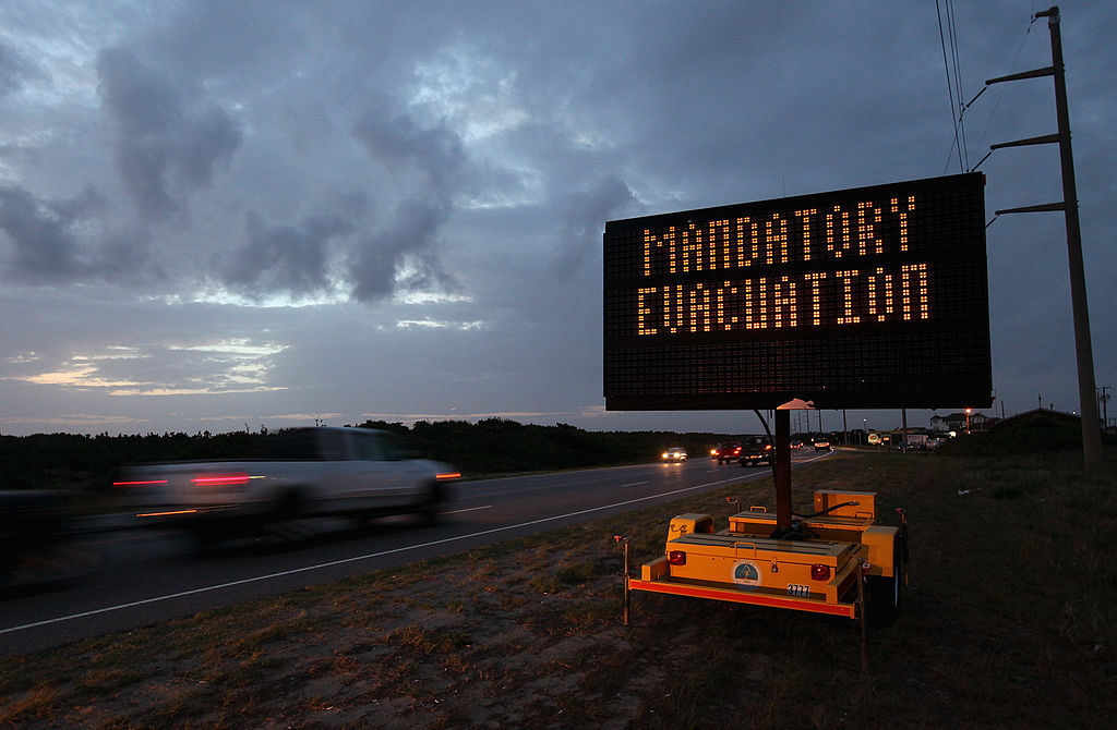 a highway sign warns motorists of mandatory evacuation