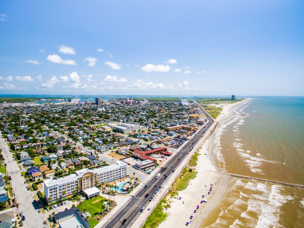 aerial photo of the galveston island sea wall and beach
