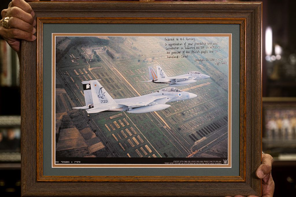 Ramirez holds a photo given to him by Gabi Ashkenazi, Chief of Defense of Israeli Defense Forces of two Israeli fighter jets flying over Auschwitz concentration camp