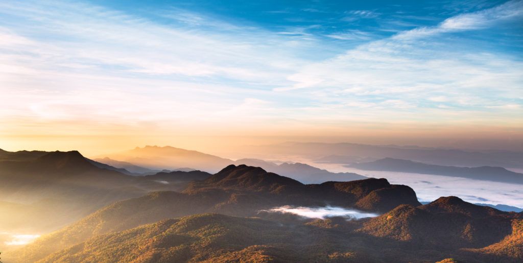 clouds over a mountainous terrain