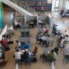 overhead view of students seated at round tables in a dining hall