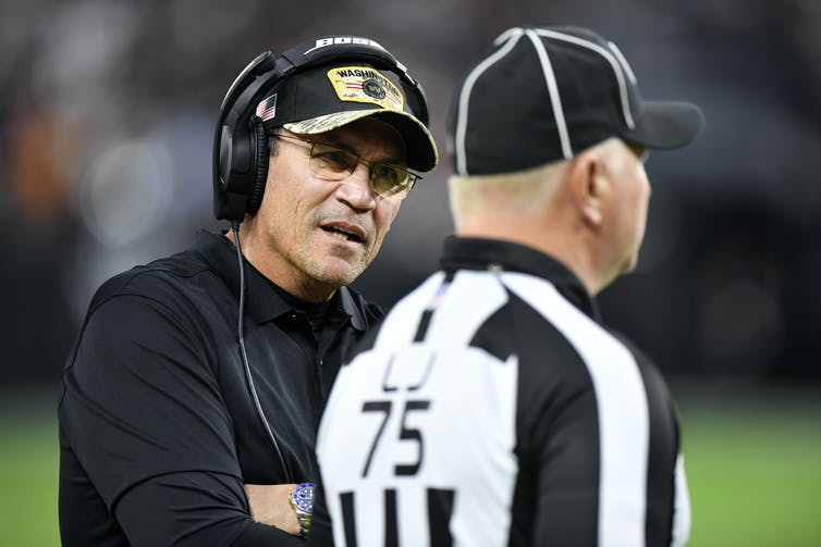 ron rivera talking to a referee on sidelines