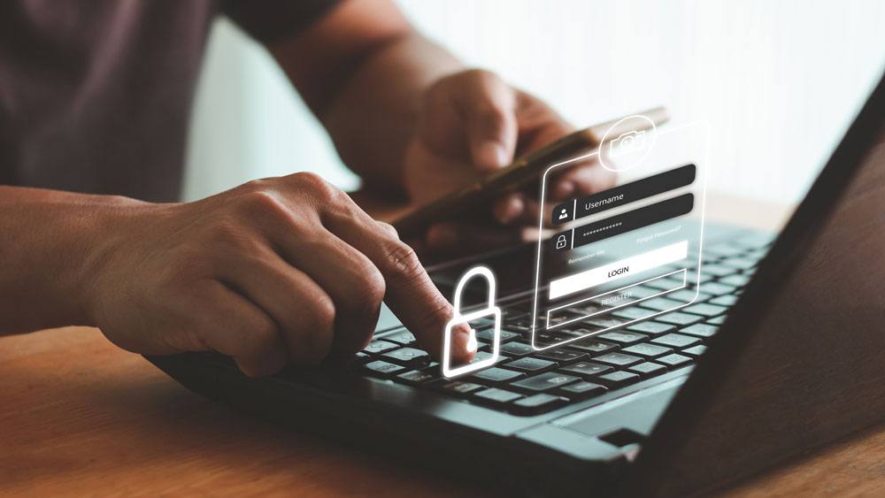artist's rendering of a man sitting at a laptop with an illustration overlay that depicts log-in security