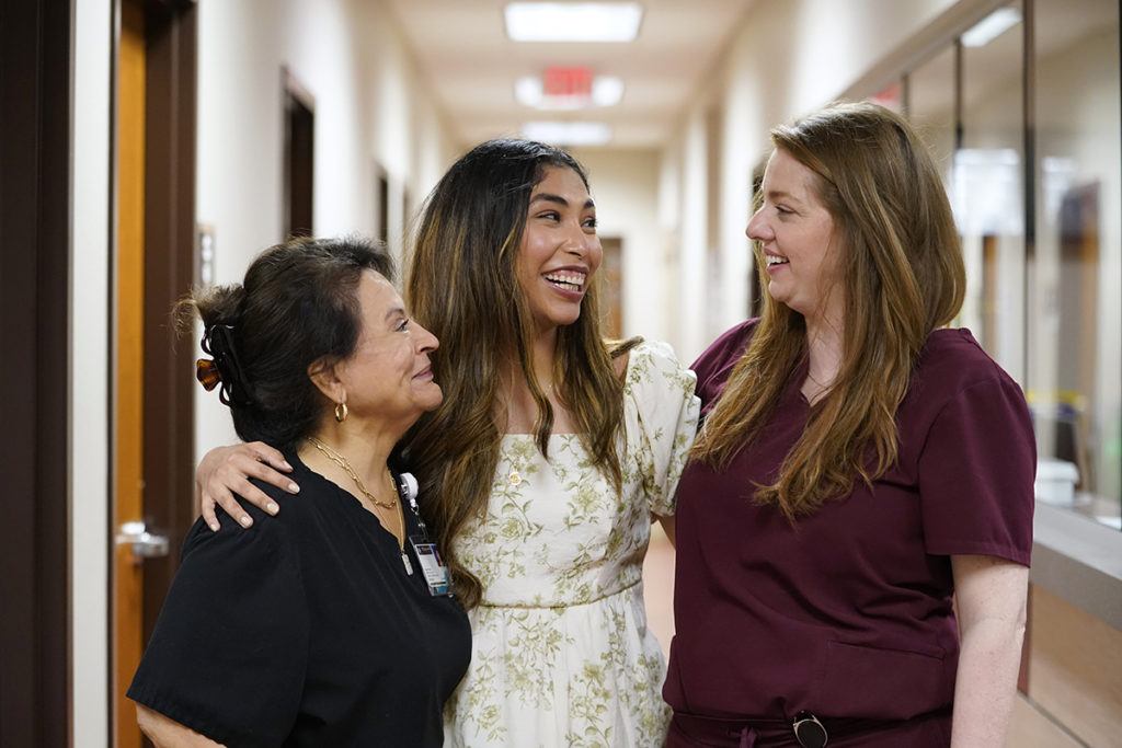 Texas A&M University student Andrea Nuñez stands between Diana Bigley, LVN, and Claire Kolb, a board certified physician assistant, at Student Health Services (SHS), the on-campus healthcare provider for Texas A&M University students, at the A.P. Beutel Health Center on April 12, 2022.