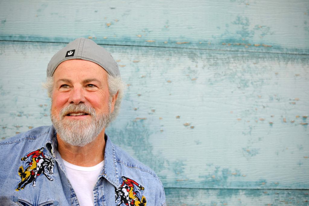 robert earl keen standing against a blue wall