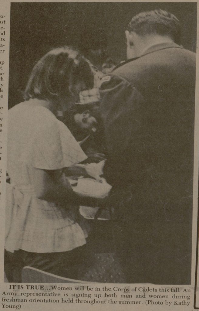 a newspaper clip with a photo showing the backs of a young woman and man in a military uniform