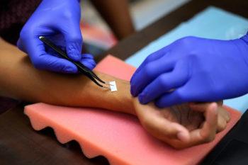 close up image of the e-tattooo being applied to a person's wrist