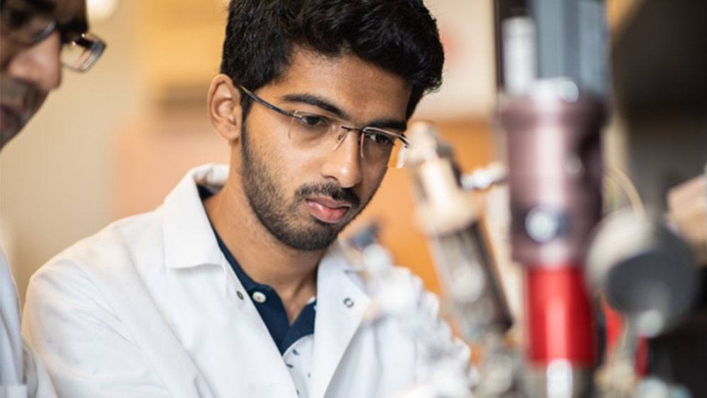 Close-up portrait of a graduate student researcher in the lab
