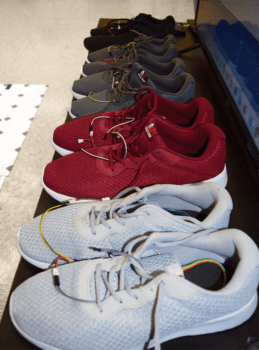 a photo of a line of shoes of different colors with wires sticking out of all of them