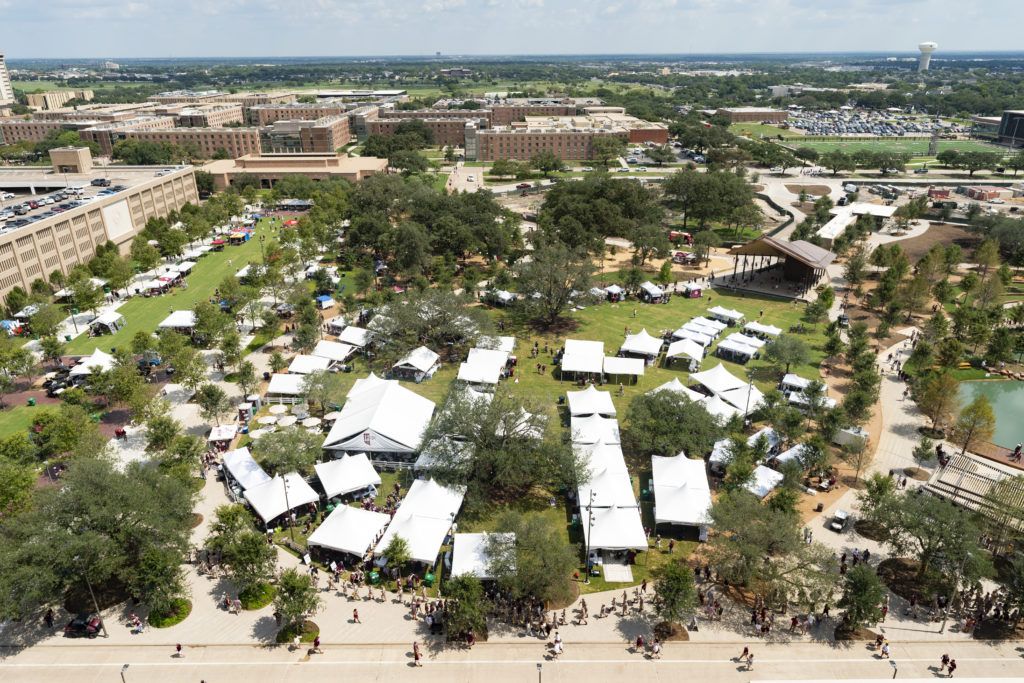 an overhead shot of the Aggie Park grand lawn full of tents and people