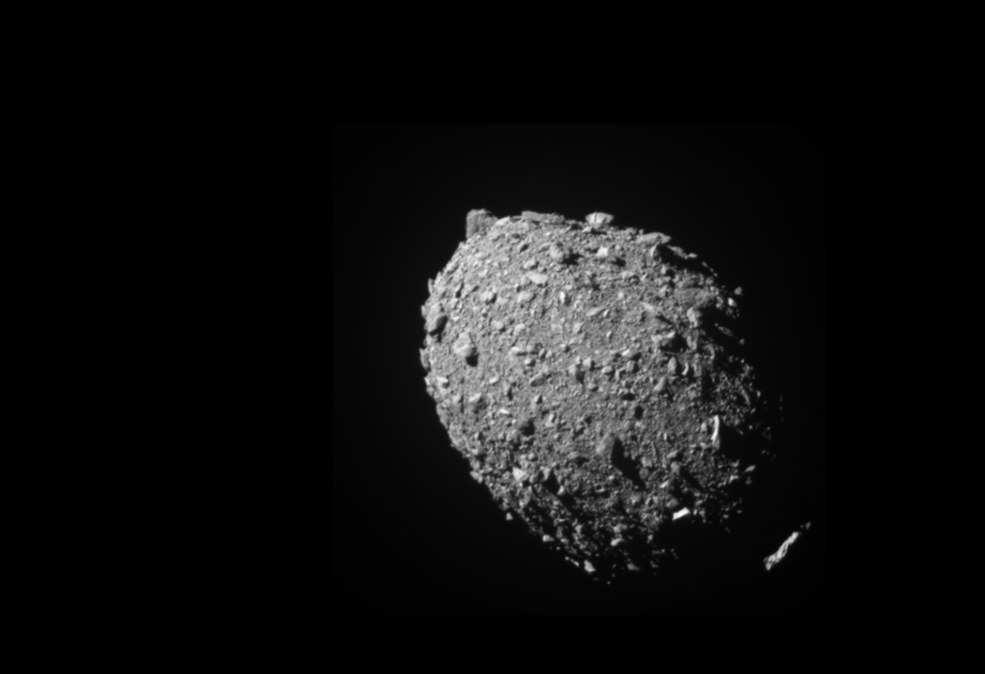 a photo of the rocky gray surface of an asteroid against the blackness of space