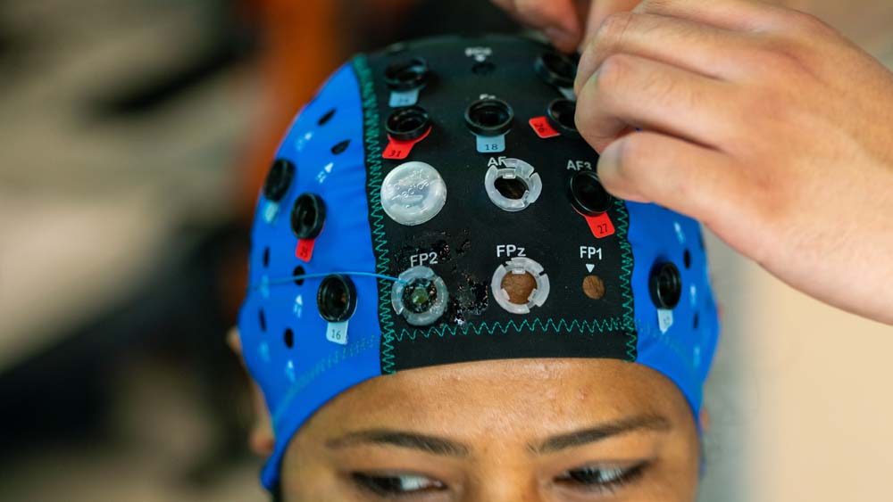 close-up of a woman wearing a track equipped with technology to capture brain activity