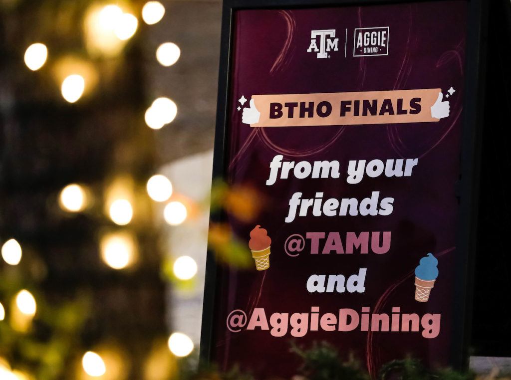 Close up of a sign that says "BTHO Finals" with twinkling lights in the background