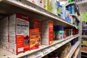 Boxes of children's motrin on a shelf at a pharmacy