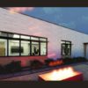 a rendering of the back exterior of the house at night, with a lit fire pit